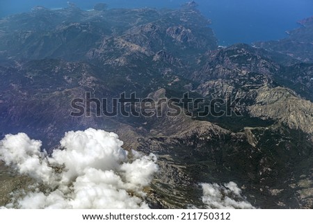 OLBIA, ITALY-JULY 18, 2014: coastal and mountains landscape of Sardinia seen through an Easyjet airplane window, in Olbia.