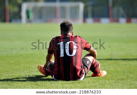 MILAN, ITALY-SEPTEMBER 13, 2014: AC Milan youth soccer player, Davide Di Molfetta, setas on the grass, during the match AC Milan vs Cittadella, in Milan.