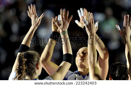MILAN, ITALY-OCTOBER 10, 2014: italian team players giving high five before the indoor female volleyball match Italy vs Russia during the Volleyball World Cup, in Milan.