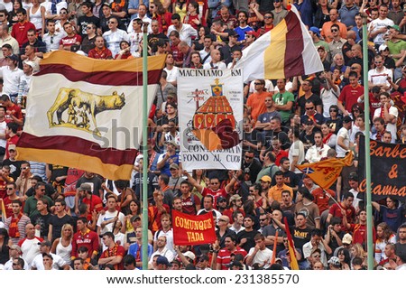MILAN, ITALY-MAY 18, 2007: AS Roma soccer fans waving flags to support their team, during the soccer match, FC Internazionale vs AS Roma, in Milan.