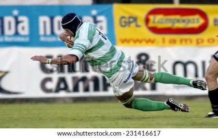 TREVISO, ITALY-MAY 28, 2005: Treviso rugby player jumps to score a try during the italian final rugby match, Treviso vs Calvisano, in Treviso.