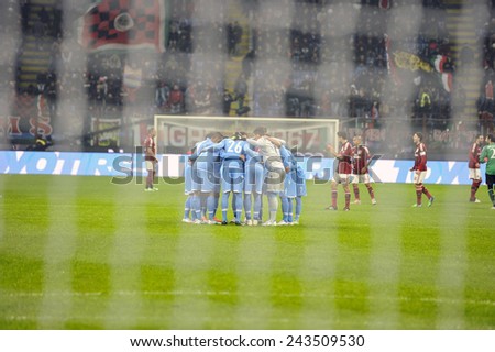 MILANO, ITALY-DECEMBER 14, 2014: Napoli soccer players seen through the goal net, gathering at san siro stadium at the start of the italian serie A soccer match AC Milan vs Napoli, in Milan.