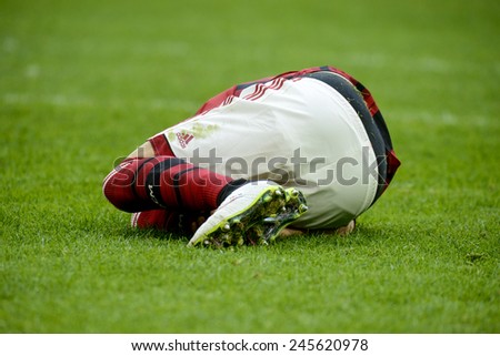 MILAN, ITALY-JANUARY 18, 2015: soccer player laying on the grass for injury at the san siro stadium, at the end of the italian serie A soccer match AC Milan vs Atalanta, in Milan.