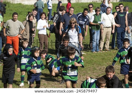 MONZA, ITALY-OCTOBER 25, 2010: parents watching their children playing a mini rugby match, in Monza.
