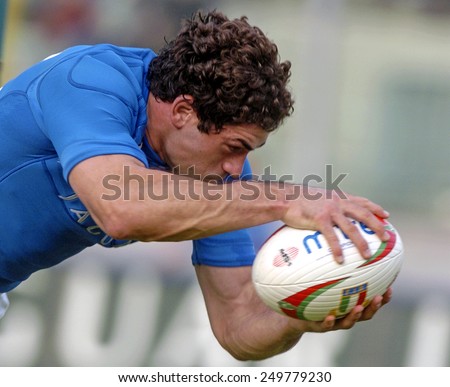 L\'AQUILA, ITALY-NOVEMBER 11, 2004: italian rugby player Andrea Masi holds the ball to score a try during the rugby test match Italy vs Canada, in L\'Aquila.