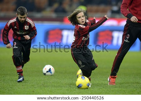 MILAN, ITALY-FEBRUARY 01, 2015: AC Milan young soccer players playing for soccer fans at the san siro stadium during the half time of a serie A match AC Milan vs Parma, in Milan.