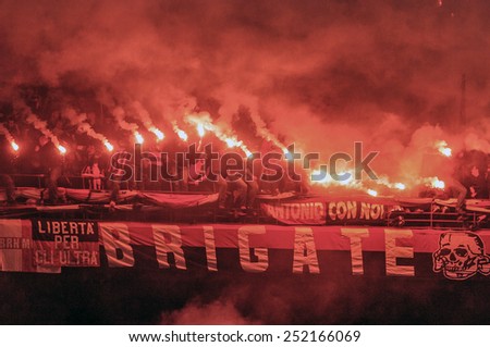 MILAN, ITALY-OCTOBER 11, 2005:  red smoke firecrackers at the san siro soccer stadium, during the derby match AC Milan vs FC Internazionale,in Milan.