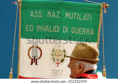 MILAN, ITALY-AUGUST 18, 2005: an old italian man invalid of the second world war with the italian flag during the anniversary celebrations of the freedom from the nazi occupation of Italy, in Milan.