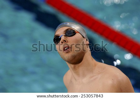 EINDHOVEN, HOLLAND-MARCH 20, 2008: swimmer wearing swim googles and and swim cap with indoor swimming pool in the background at the European Swimming Championship, in Eindhoven.