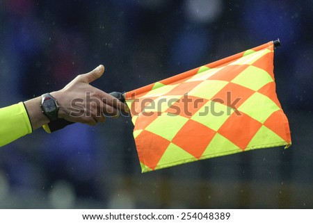 BERGAMO-ITALY-FEBRUARY 15,2015: linesman and assistant referee waving flag during the italian soccer match Atalanta vs FC Internazionale, in Bergamo.