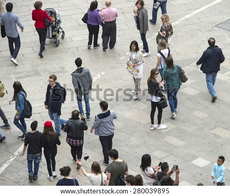 MILAN, ITALY-MAY 05, 2015: top view of people walking in Duomo square, with the apple  art installation of the Italian artist Pistoletto, in Milan.