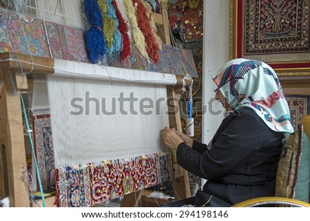 ISTANBUL, TURKEY-MAY 30,2015: veiled woman makes handcraft carpet, in Istanbul.