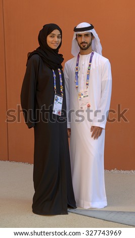 MILAN, ITALY-OCTOBER 07, 2015: Young arab man and young arab woman wearing traditional dress at the United Arab Emirates pavillion at EXPO 2015, in Milan.