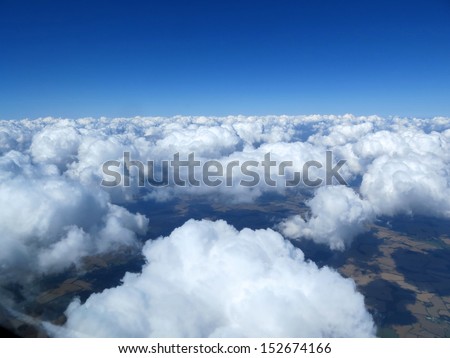 Blue sky with clouds, taken from the air. Aerial shot of cumulus clouds. Earth Day. Background.