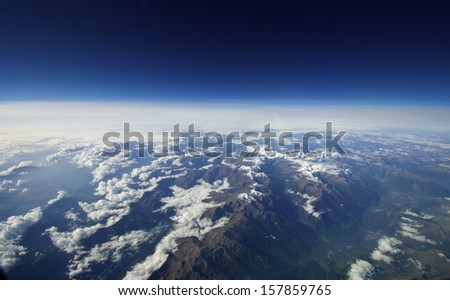 Unusual aerial cloudscape. Suitable as background or for Earth Day. A wide view of the earth and clouds.