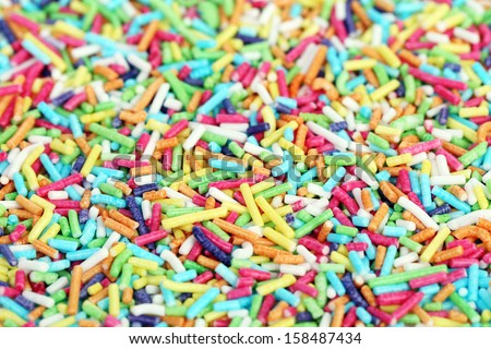 Colored sugar sprinkles for food decoration. Whole background.