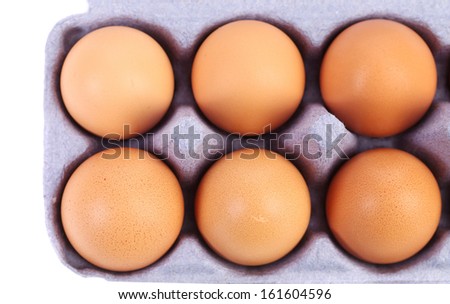 Brown eggs in egg box. Isolated on a white background