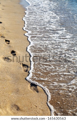 Sand and wave on the sea. Vertical. Whole background.