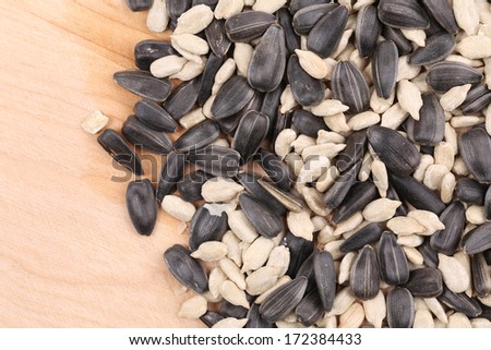 Sunflower seeds black and white on wooden board