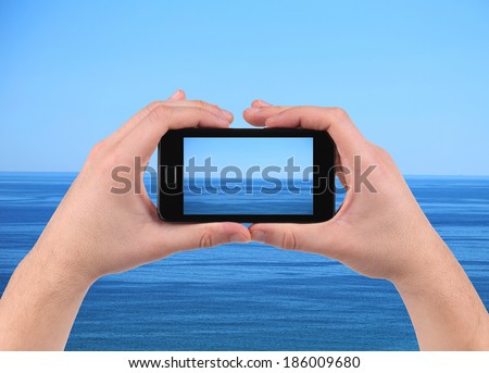 Sea reflection on screen. Cell phone. Whole background.