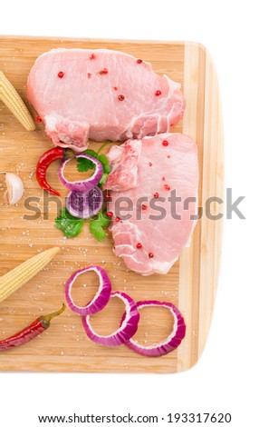 Meat composition on wooden platter. Whole background.