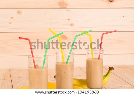 Banana fresh juice with straw. Whole background.
