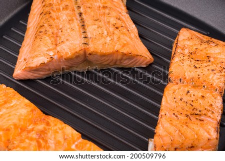 Grilled salmon steaks on frying pan. Close up.