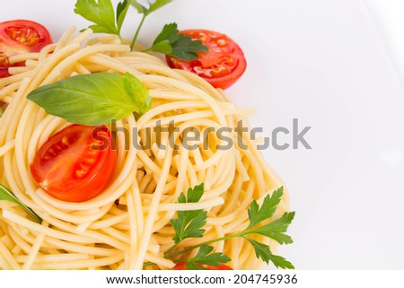 Italian pasta with basil and parsley. Isolated on a white background.