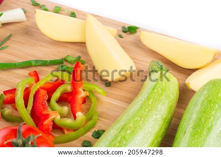 Close up of vegetables on wooden platter. Whole background.
