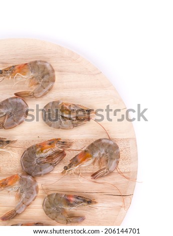 Fresh shrimps on round board. Whole background.