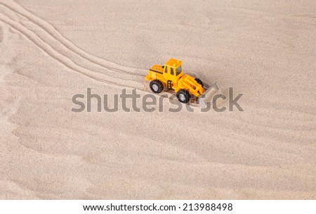 Yellow loader on the sand. Close up.