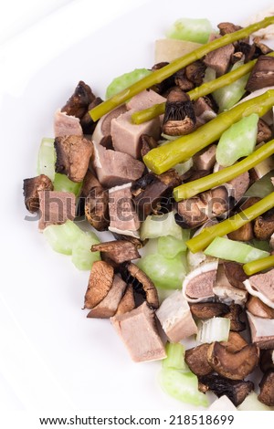 Delicious salad with beef tongue as haute cuisine in the closeup isolated