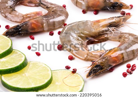 Raw shrimps with lemon. Isolated on a white background.