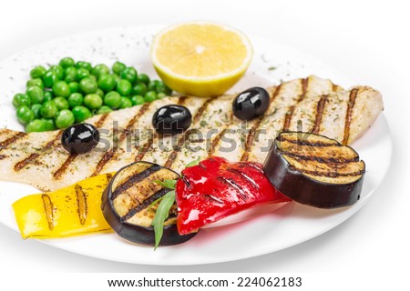 Grilled fish with vegetables. Isolated on white background.