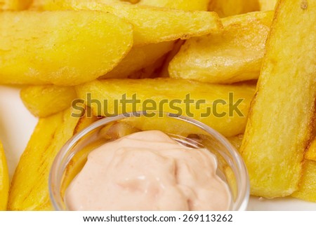 Delicious potato wedges with sauce. Fast food. Can be used as a whole background.