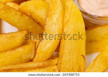 Delicious potato wedges with sauce. Fast food. Can be used as a whole background.