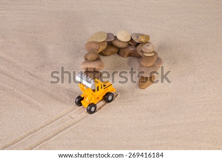 Yellow loader on the sand. Close up.