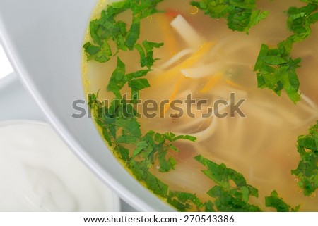 Noodle soup with herbs and carrot. Macro. Can be used as a whole background.