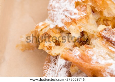 Closeup of heat apple puff cake in cardboard box. Macro. Can be used as a whole background.