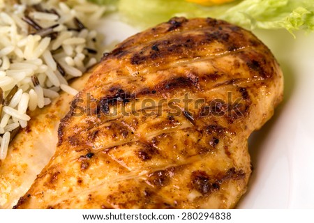Delicious grilled chicken fillet with basmatic rice and lettuce. Macro. Photo can be used as a whole background.