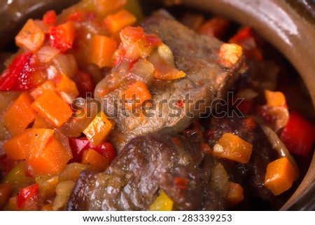 Pot roast pork meat with minced vegetables as a traditional balkan kitchen. Macro. Photo can be used as a whole background.