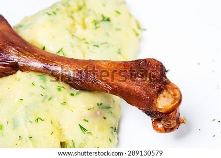 Delicious duck leg confit with delicate potato puree and posemary. Macro. Photo can be used as a whole background.