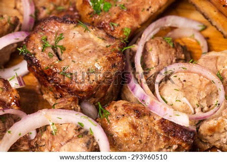 Delicious grilled pork meat with onion. Macro. Photo can be used as a whole background.