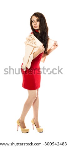 Beautiful young brunette model in red dress and yellow high heel shoes. Side view. Full length portrait. Isolated on a white background.