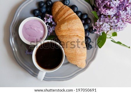 breakfast with croissants,coffee, blueberries and yogurt
