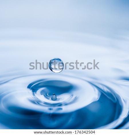 Water Drop In Dark Blue Color With A Drop Of Water Flying From