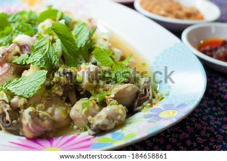 Oyster shrimp squid with side dishes such as vegetables, pepper, garlic