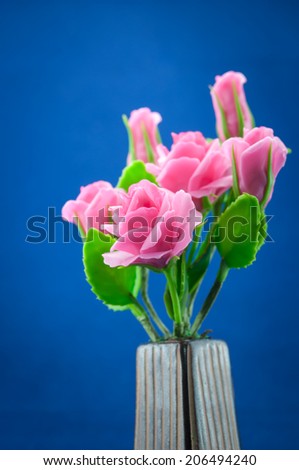 Artificial Flowers made of japanese clay on blue background