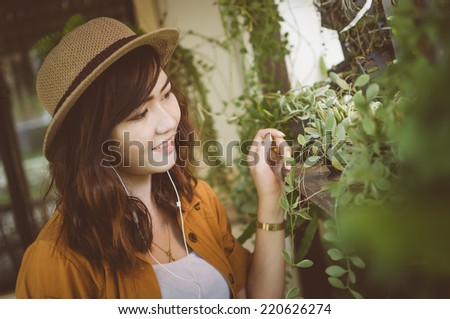 Woman listening to music with earphones in the park, Color effect