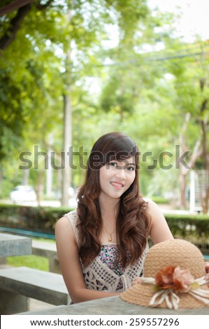 Woman sitting on stone chair in the park